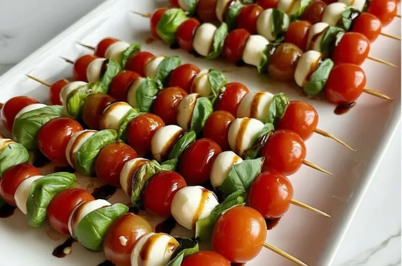Delicious Caprese skewers with mozzarella, cherry tomatoes, and fresh basil leaves.