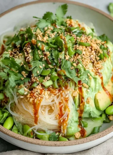 Delicious cold sesame miso noodles topped with vegetables and sesame seeds.