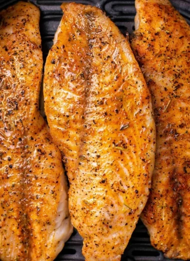 Crispy air fryer tilapia served with vegetables on a plate