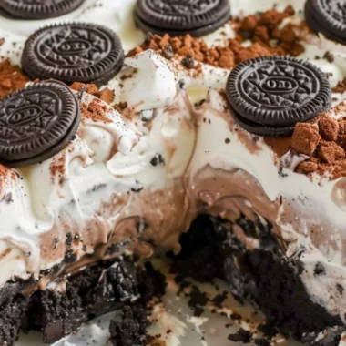 Delicious no bake Oreo dessert topped with Cool Whip and Oreo crumbs.
