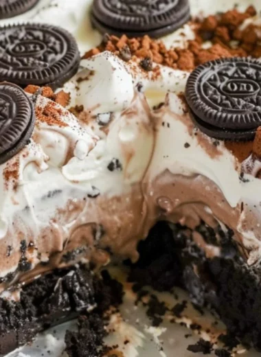 Delicious no bake Oreo dessert topped with Cool Whip and Oreo crumbs.