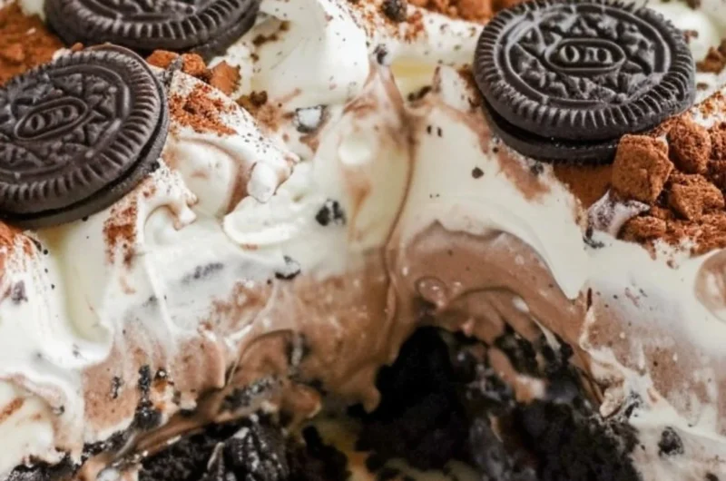 Delicious no bake Oreo dessert topped with Cool Whip and Oreo crumbs.