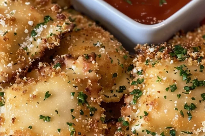 Crispy air fryer ravioli arranged on a plate with dipping sauce.