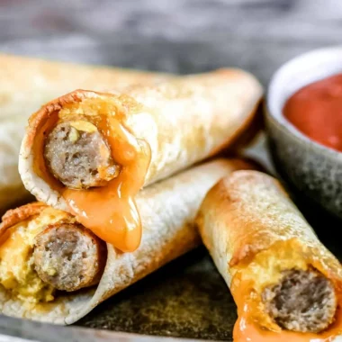 Plate of easy breakfast taquitos with eggs, cheese, and salsa