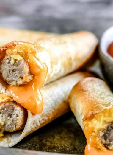 Plate of easy breakfast taquitos with eggs, cheese, and salsa