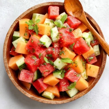 Easy melon salad with honey lime dressing served in a bowl.