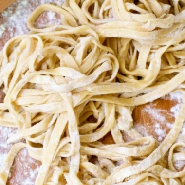 Bowl of homemade egg noodles ready for cooking in a delicious broth.