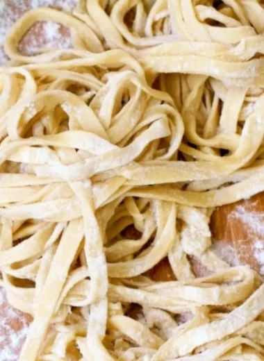 Bowl of homemade egg noodles ready for cooking in a delicious broth.