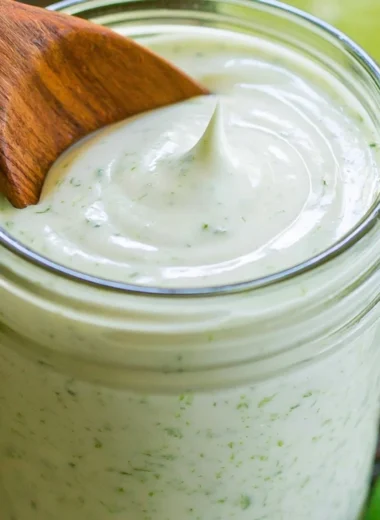 Bottle of Jalapeno Ranch Dressing with fresh jalapenos and herbs