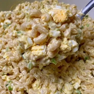 Bowl of Mom's creamy macaroni salad with vegetables and dressing