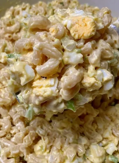 Bowl of Mom's creamy macaroni salad with vegetables and dressing
