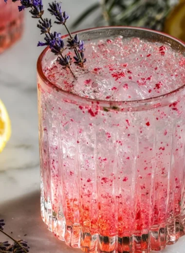 Pink Lavender Lemonade with fresh lavender and essential oils in a glass.