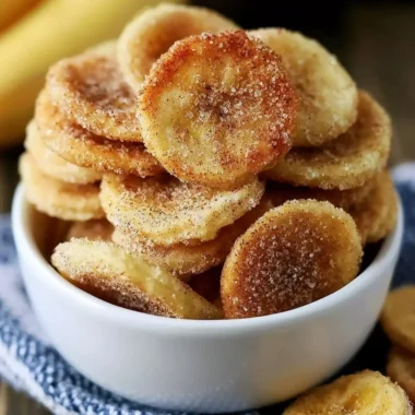Crispy cinnamon-sugar air fryer banana chips on a plate