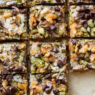 Delicious homemade Seven Layer Bars stacked with chocolate and coconut layers
