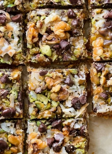 Delicious homemade Seven Layer Bars stacked with chocolate and coconut layers