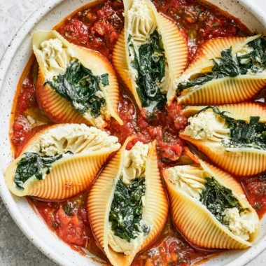Vegan stuffed shells filled with savory plant-based ingredients on a plate.