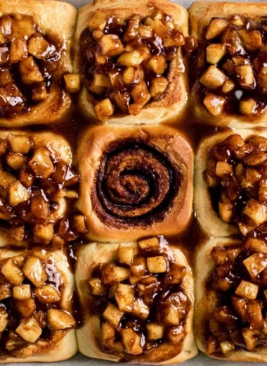 Delicious apple pie cinnamon rolls topped with icing and cinnamon.
