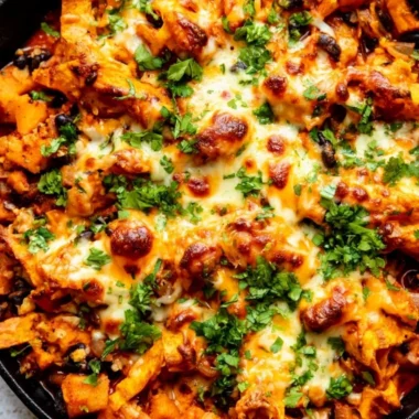 Delicious butternut squash enchiladas skillet with black beans and toppings