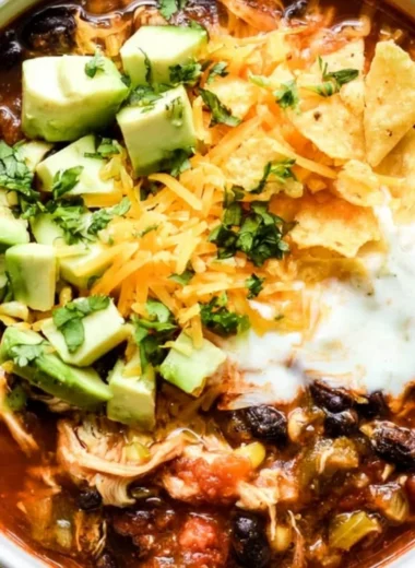 Delicious bowl of Crockpot Chicken Enchilada Soup topped with cheese and cilantro