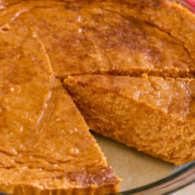 Delicious crustless pumpkin pie served on a plate with whipped cream