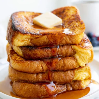 Delicious slice of easy French toast topped with syrup and berries