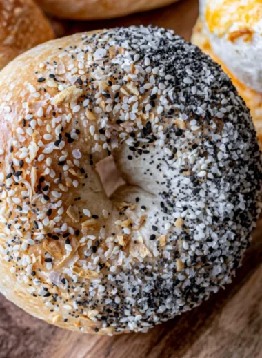 Freshly baked easy sourdough bagels on a wooden board
