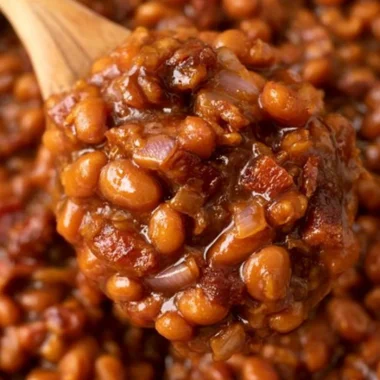 A bowl of delicious Easy Ultimate Baked Beans garnished with herbs