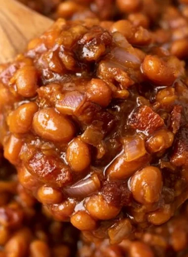 A bowl of delicious Easy Ultimate Baked Beans garnished with herbs