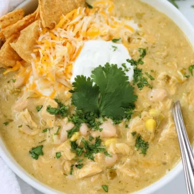Bowls of Green Chile Chicken Enchilada Soup topped with cilantro and cheese
