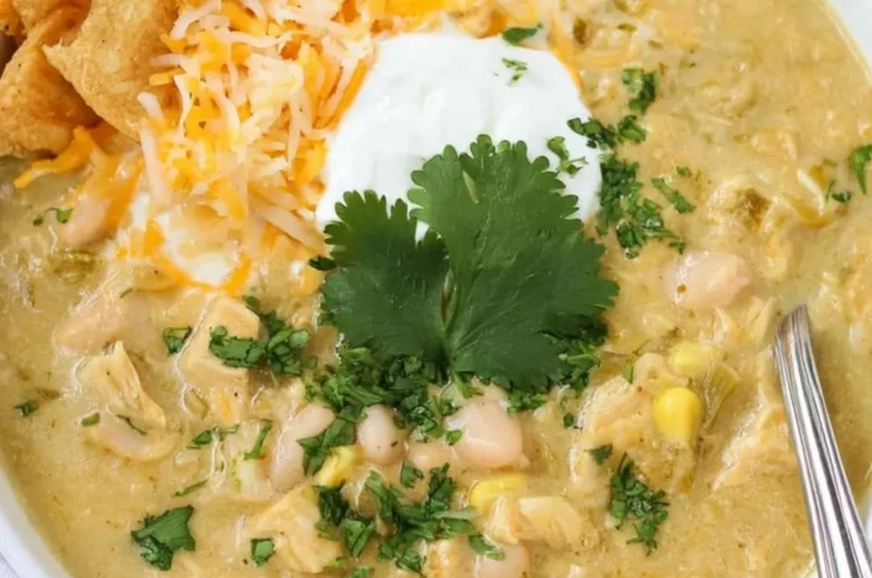 Bowls of Green Chile Chicken Enchilada Soup topped with cilantro and cheese
