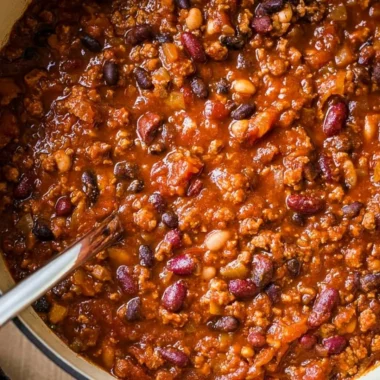Bowl of flavorful ground turkey chili topped with fresh herbs and peppers