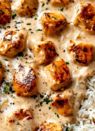 Creamy smothered chicken served with rice in a comforting meal