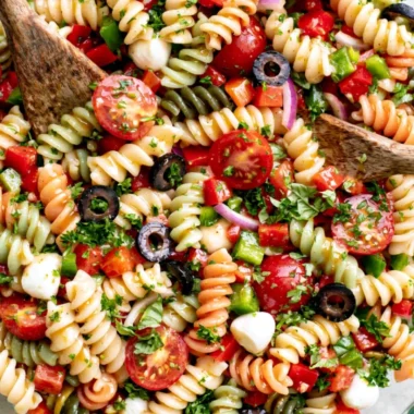 Bowl of Italian pasta salad with colorful vegetables and dressing