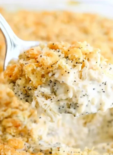 Poppy Seed Chicken Casserole served in a baking dish with fresh herbs