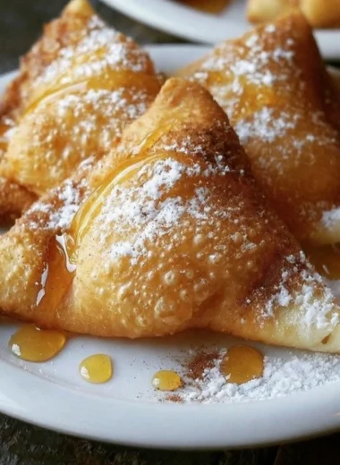 Freshly made sopaipillas garnished with honey and powdered sugar