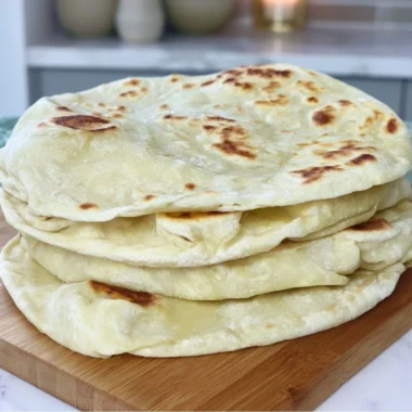 Homemade sourdough discard tortillas on a wooden surface