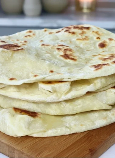 Homemade sourdough discard tortillas on a wooden surface