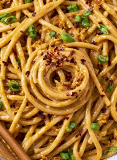Delicious vegan garlic noodles served in a bowl with herbs