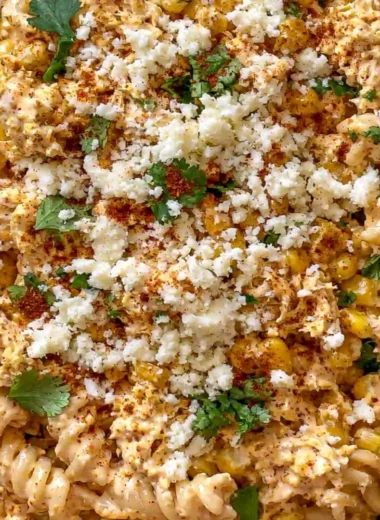 Zesty Mexican Street Corn Chicken Pasta Salad in a bowl garnished with fresh herbs