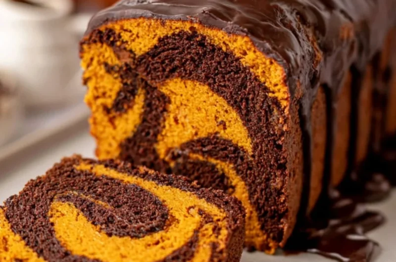 Vegan Pumpkin Marble Cake beautifully sliced with decorative pumpkin garnish.