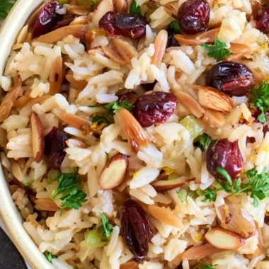 Delicious Cranberry Rice Pilaf served on a plate with fresh herbs