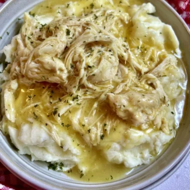 Delicious slow cooker chicken and gravy served with mashed potatoes
